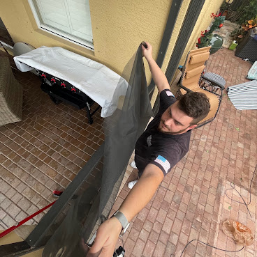Technician installing window screen